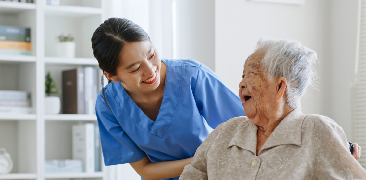 medical assistant taking care of aging patient