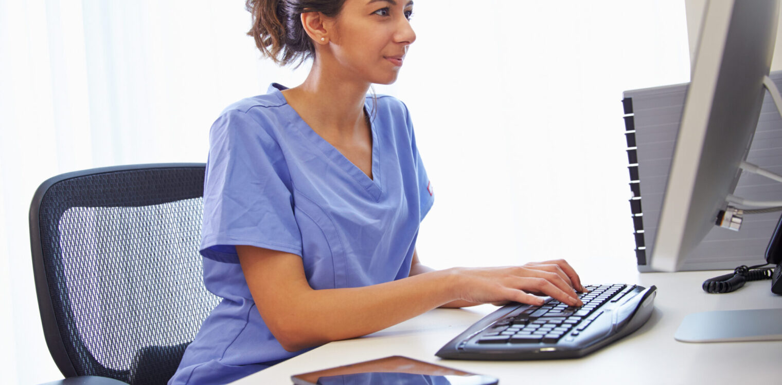Female medical professional In Office Working At Computer